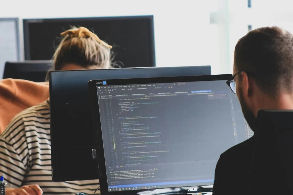 Developers on a laptop producing php code